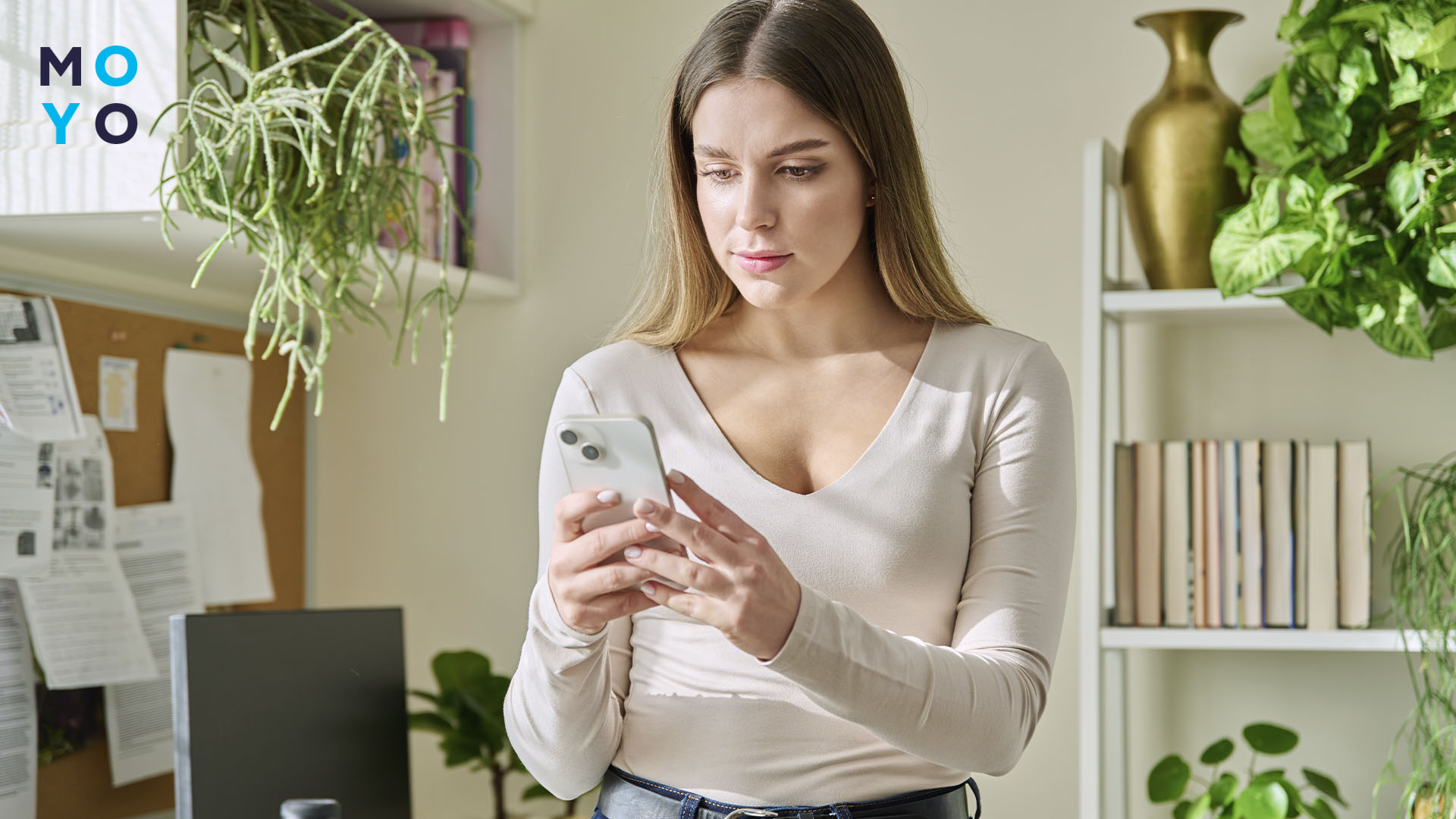 Дівчина дивиться на екран смартфона